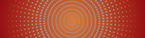 Radiant gray dots on a background gradient from an orange center to brick red edges.